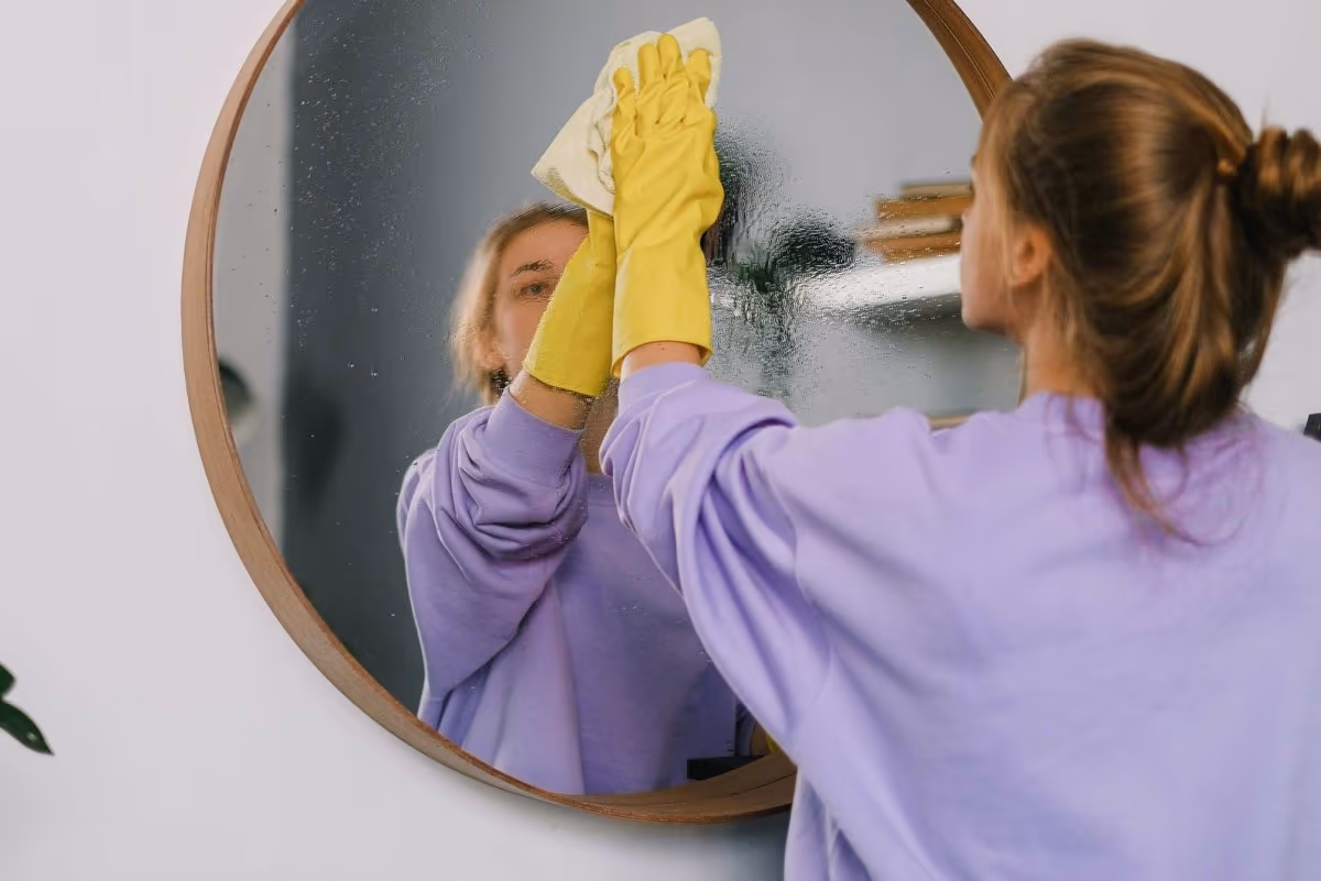 Female cleaner providing weekly home cleaning